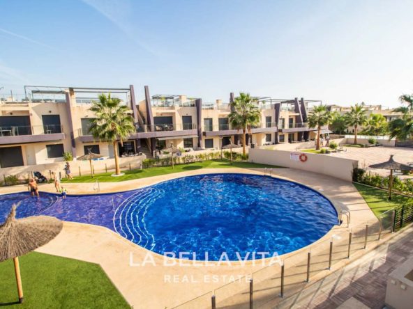 Modern Apartment with solarium for sale step away from the beach in Mil Palmeras, Alicante, Spain communal pool