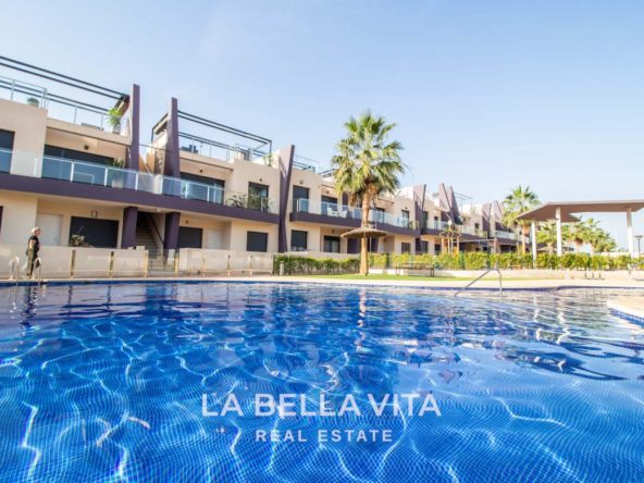 Modern Apartment with solarium for sale step away from the beach in Mil Palmeras, Alicante, Spain communal pool