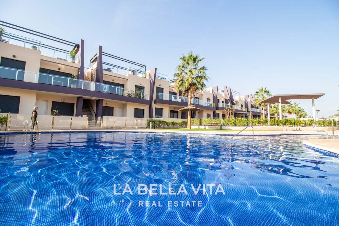 Modern Apartment with solarium for sale step away from the beach in Mil Palmeras, Alicante, Spain communal pool