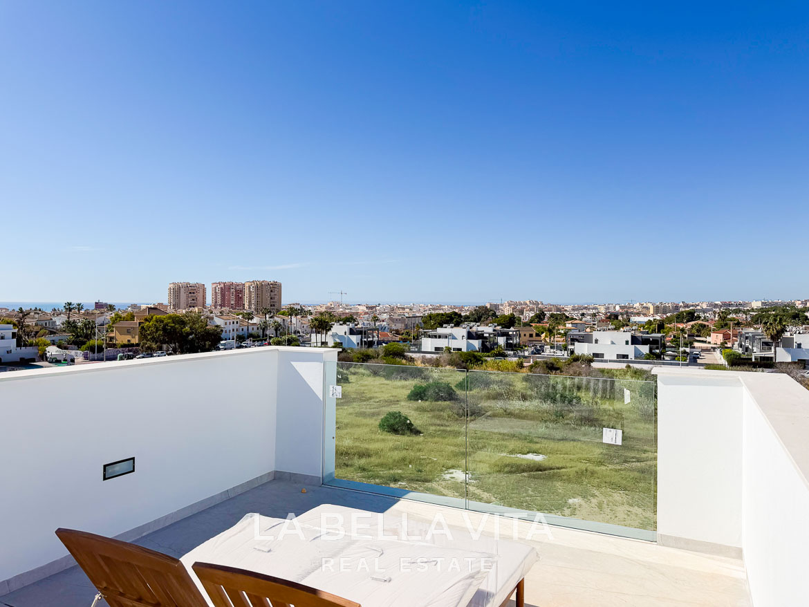 Sun-drenched terrace with glass railing and panoramic views in a modern new build villa in Aguas Nuevas, Torrevieja