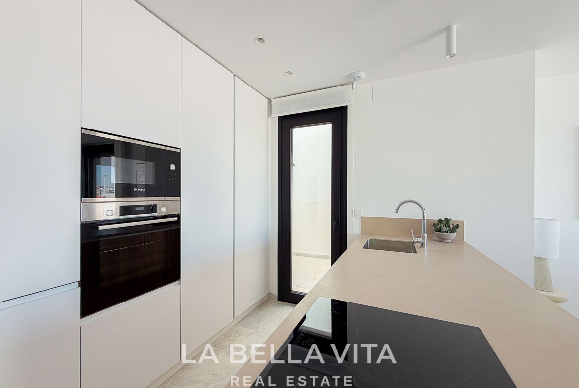 Bright modern kitchen with sleek cabinetry and integrated appliances in new build villas with private pool in Aguas Nuevas, Torrevieja