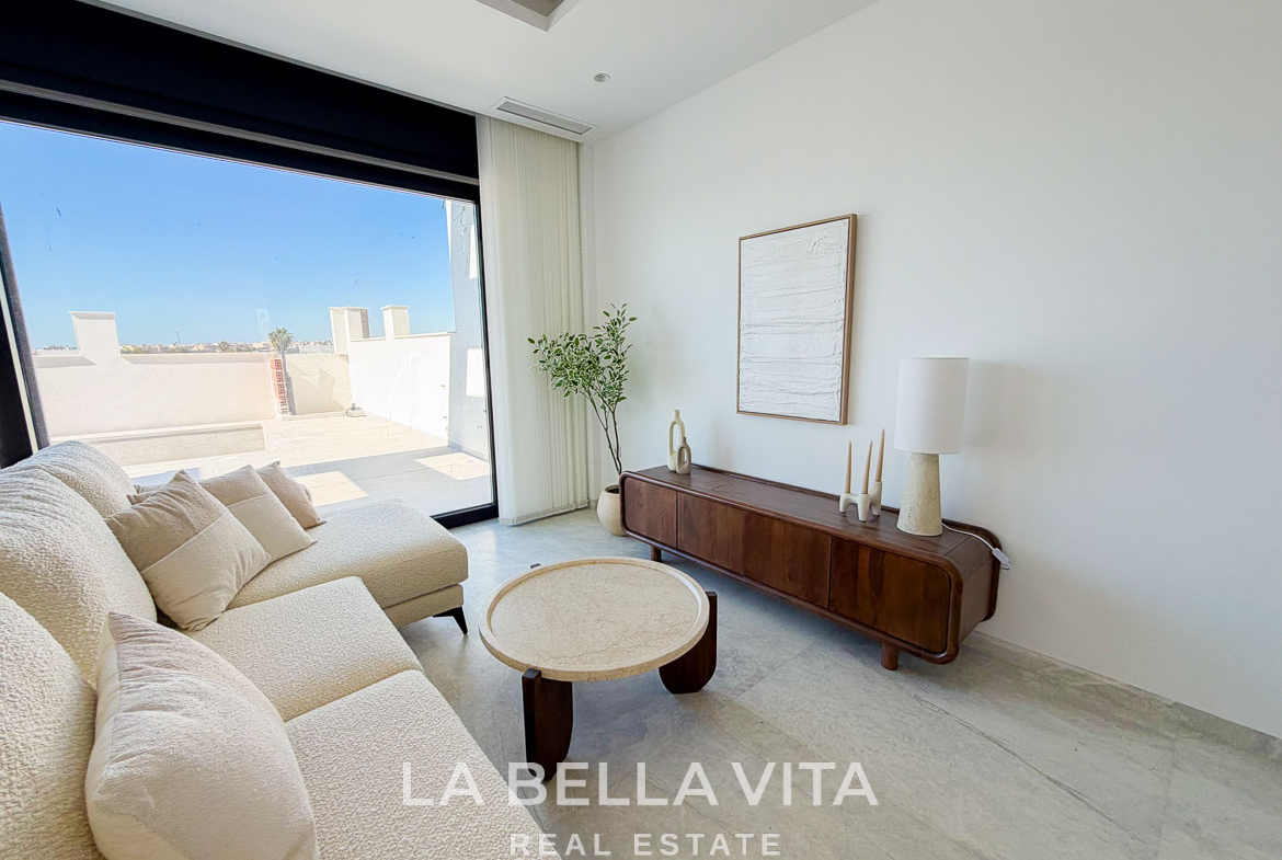 Bright, modern living room with plush sofa and sleek wooden console in new build villa with private pool in Aguas Nuevas, Torrevieja.