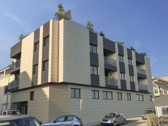 Corner view of a contemporary apartment block with balconies and rooftop planters