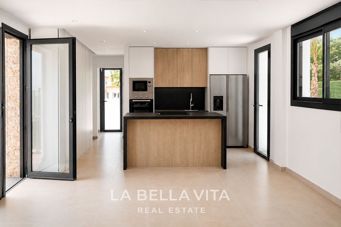 Modern, bright open-plan kitchen with sleek cabinetry in key-ready new build single-storey villa in Los Montesinos, Costa Blanca