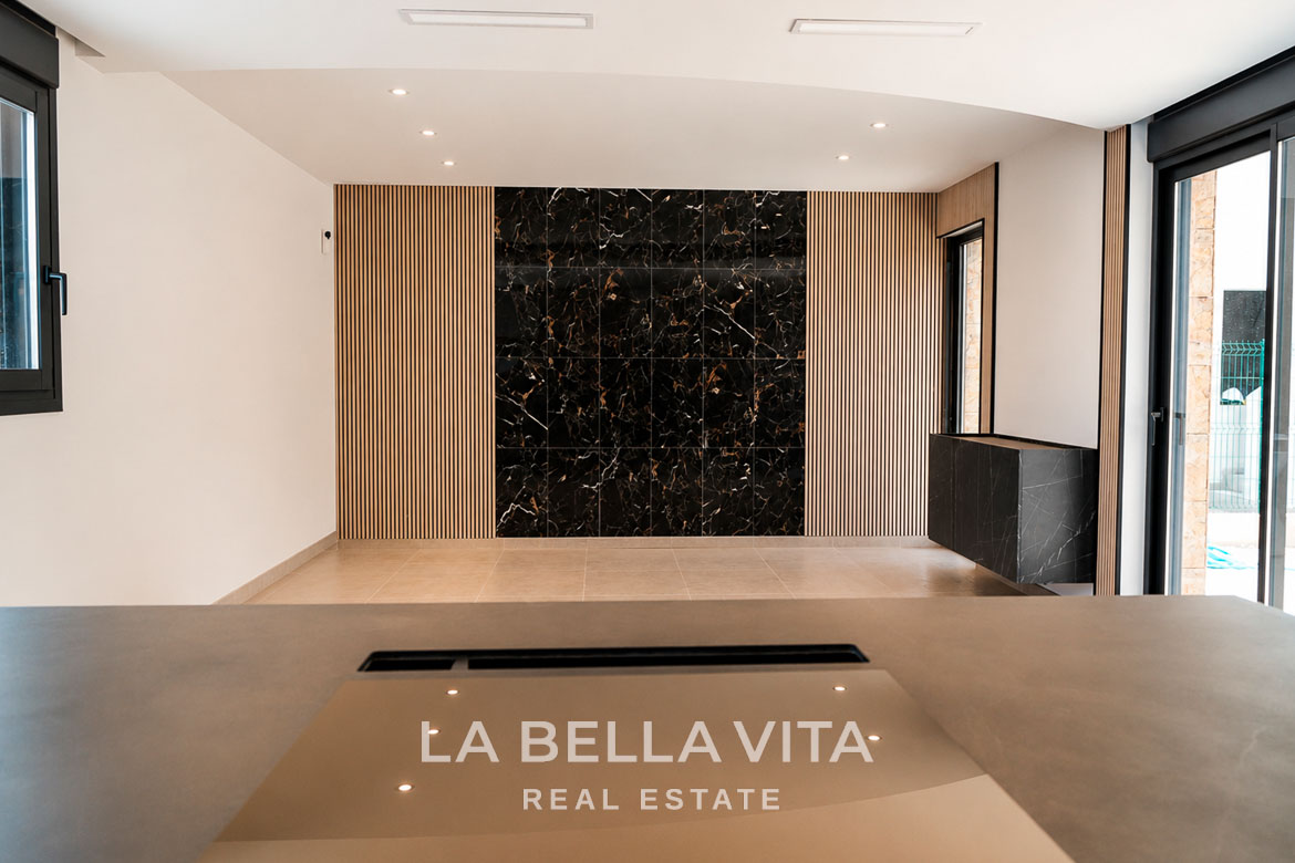 Elegant modern interior of key-ready single-storey villa in Los Montesinos with sleek black marble wall and bright open space