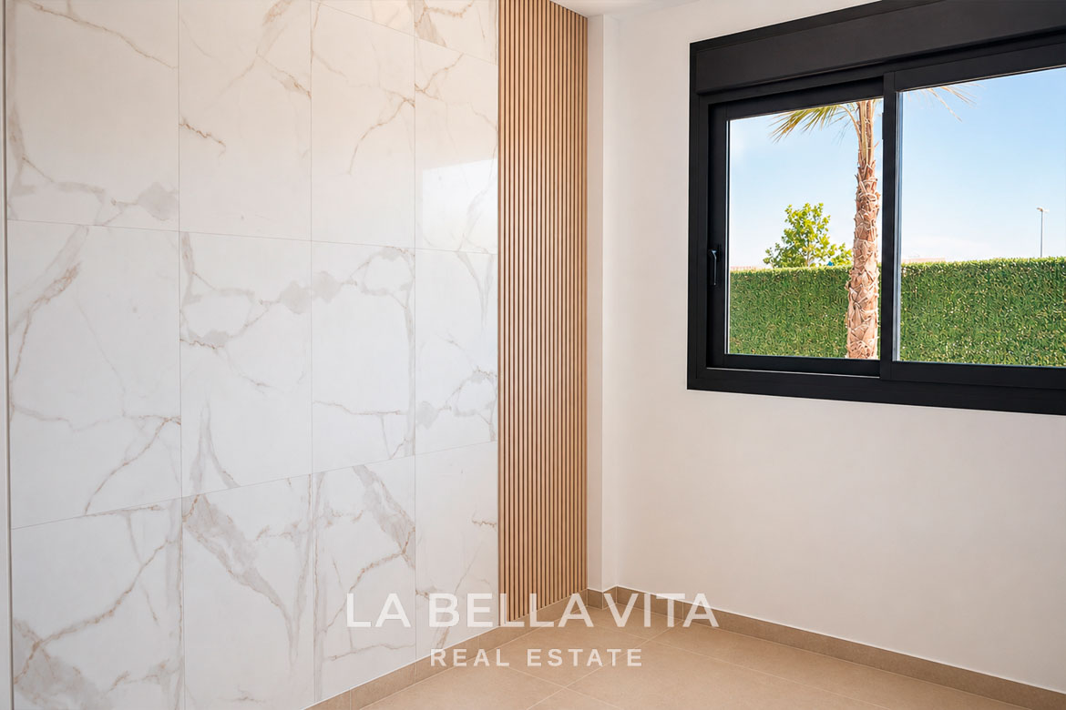 Bright modern bathroom with marble-effect tiles and sleek window in key-ready single-storey villa, Los Montesinos, Costa Blanca