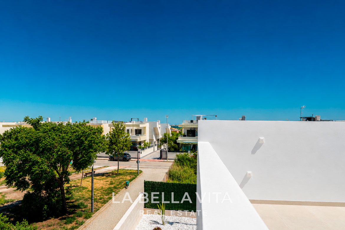 Sun-drenched terrace and modern exterior of a key-ready single-storey villa in Los Montesinos, Costa Blanca with clear blue sky.