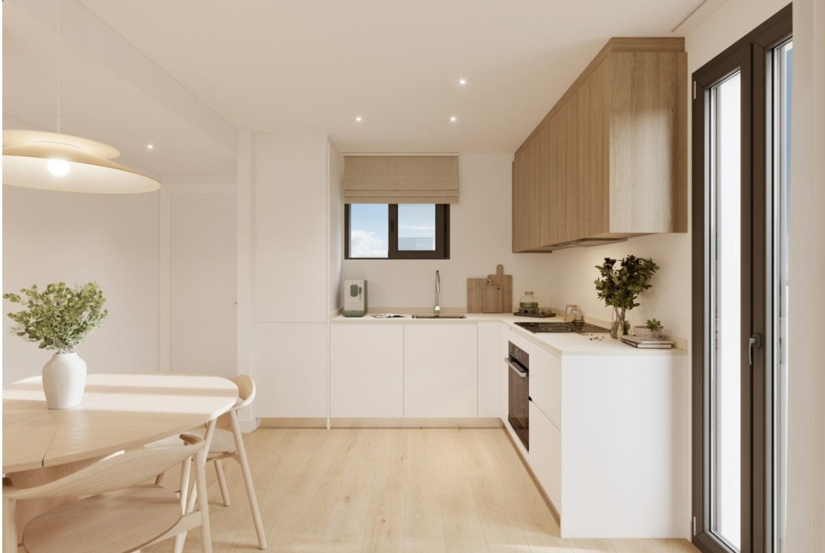 Modern kitchen and dining area in a new ground floor 2-bedroom apartment with garden in Cala de Finestrat.