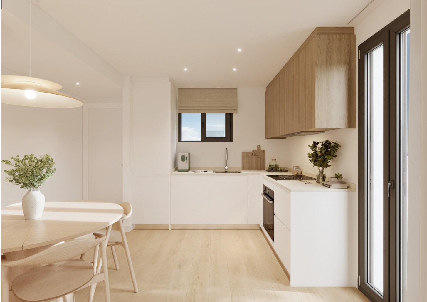 Modern kitchen and dining area in a new ground floor 2-bedroom apartment with garden in Cala de Finestrat.