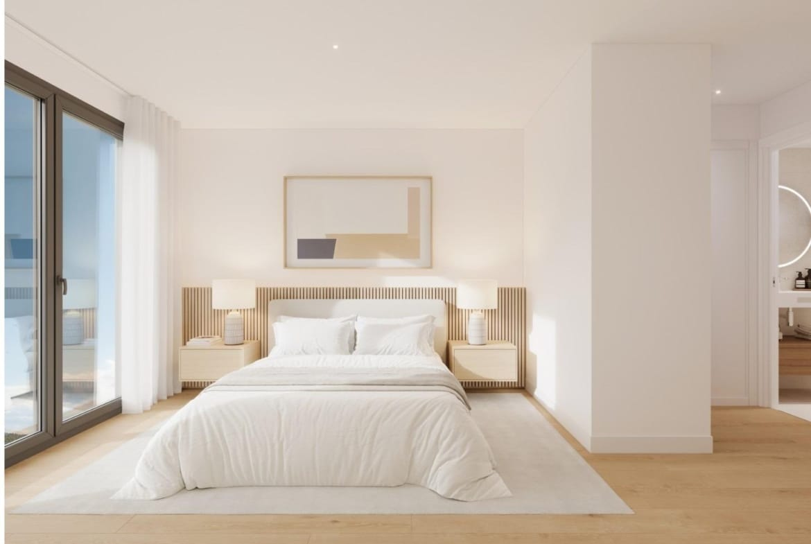 Bright bedroom with large window and balcony in a 3-bedroom penthouse in Cala de Finestrat with solarium view.