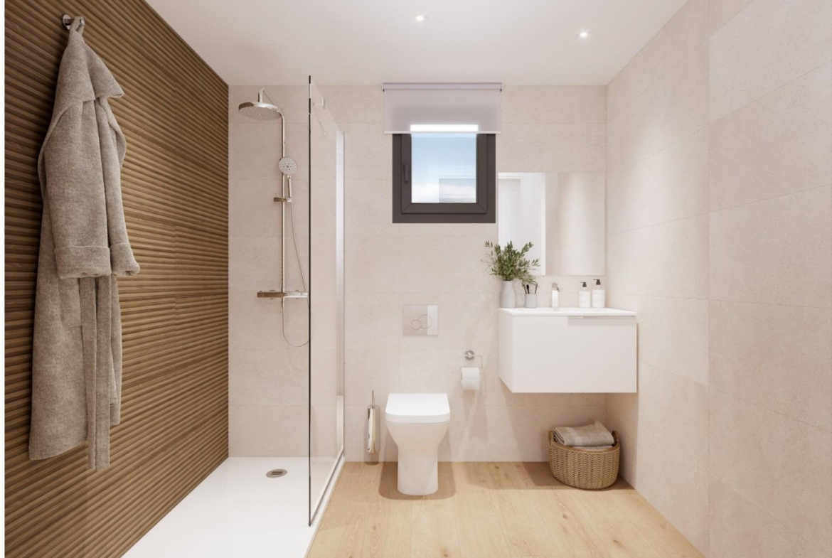 Modern bathroom with walk-in shower, toilet, and vanity in a new 2-bedroom ground floor apartment in Cala de Finestrat.