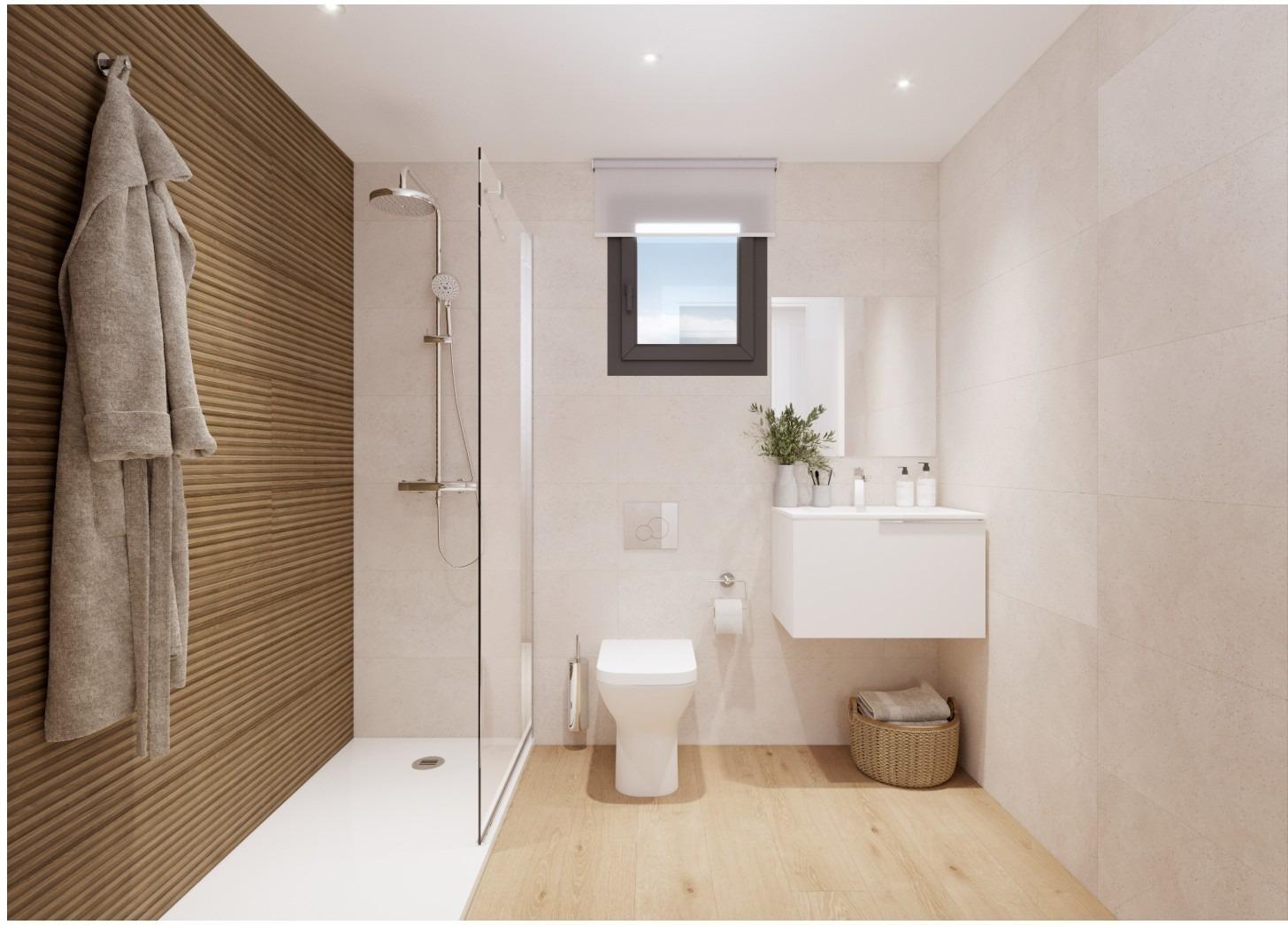 Modern bathroom with walk-in shower, toilet, and vanity in a new 2-bedroom ground floor apartment in Cala de Finestrat.