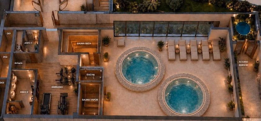Aerial view of the solarium with two round pools, lounge chairs, gym, and sauna in a 2-bedroom penthouse in Cala de Finestrat.