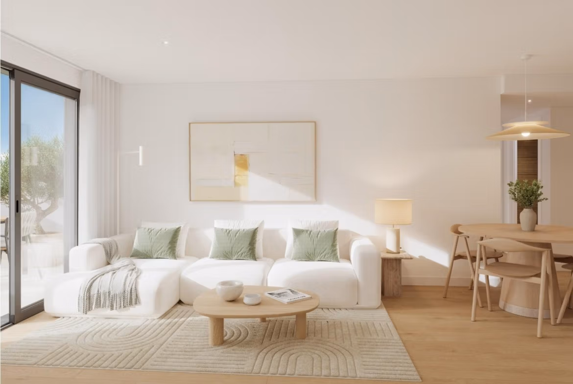 Bright living room with white sofa and dining area in a new 2-bedroom penthouse in Cala de Finestrat.