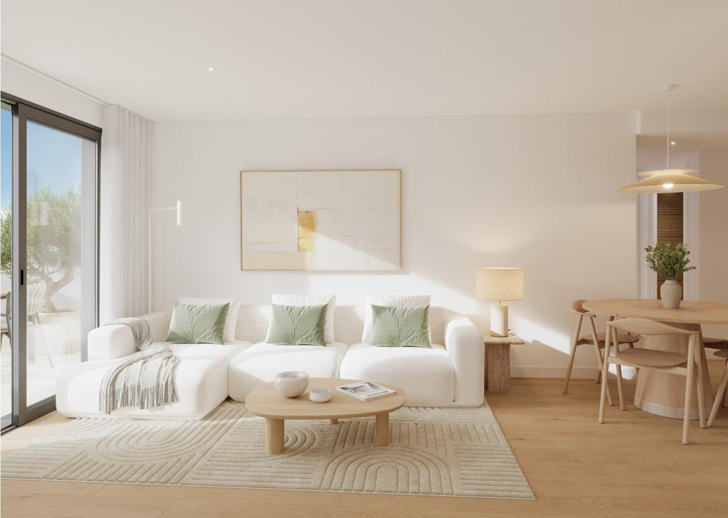 Bright living room with white sofa and dining area in a new 2-bedroom ground floor apartment in Cala de Finestrat.