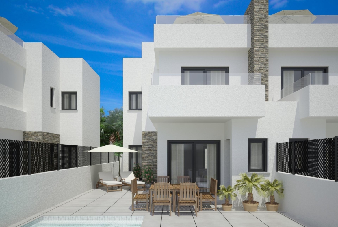 Exterior view of new build semi-detached villa with private pool and patio dining area in Vistabella Golf Resort