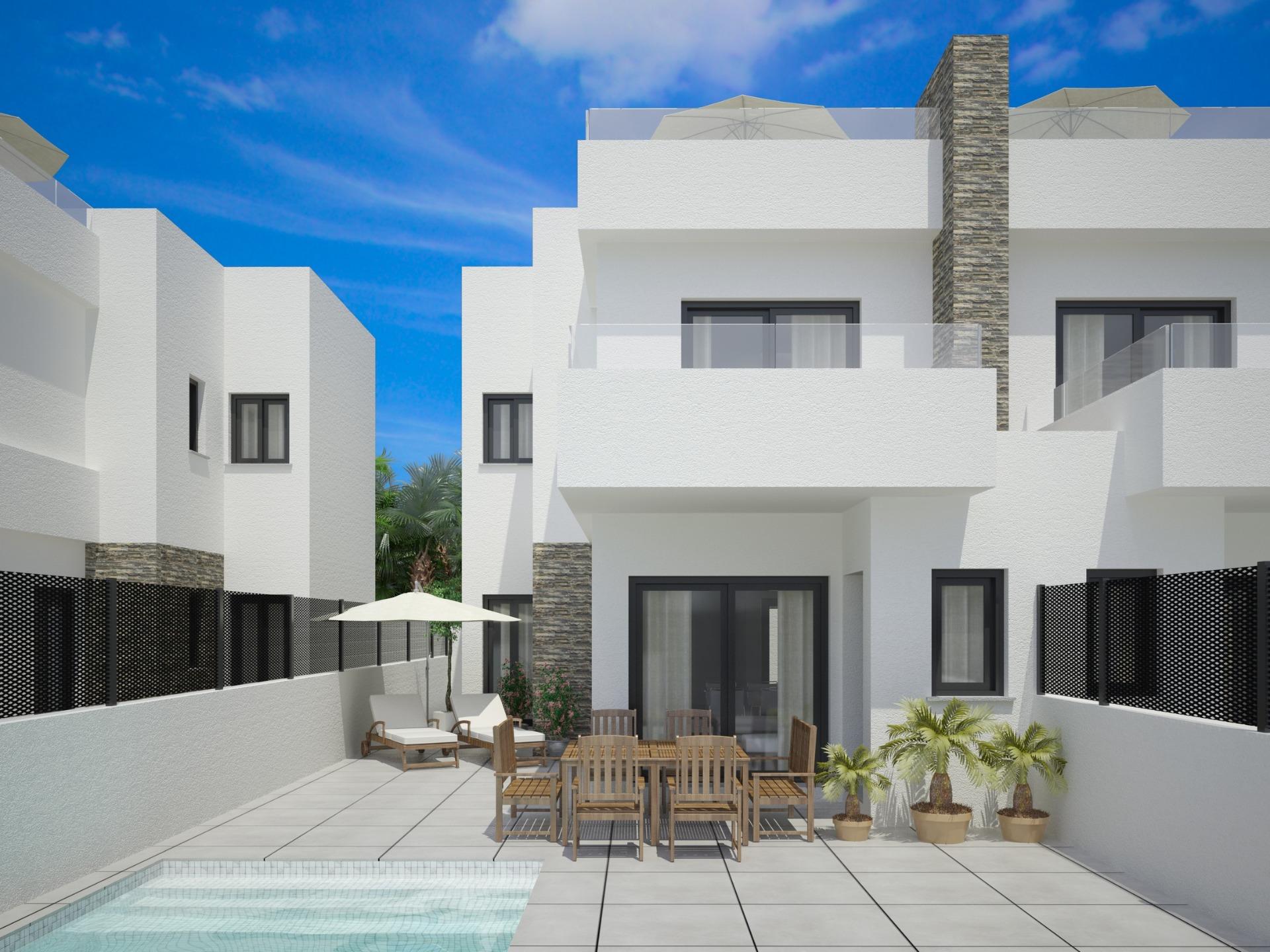 Exterior view of new build semi-detached villa with private pool and patio dining area in Vistabella Golf Resort