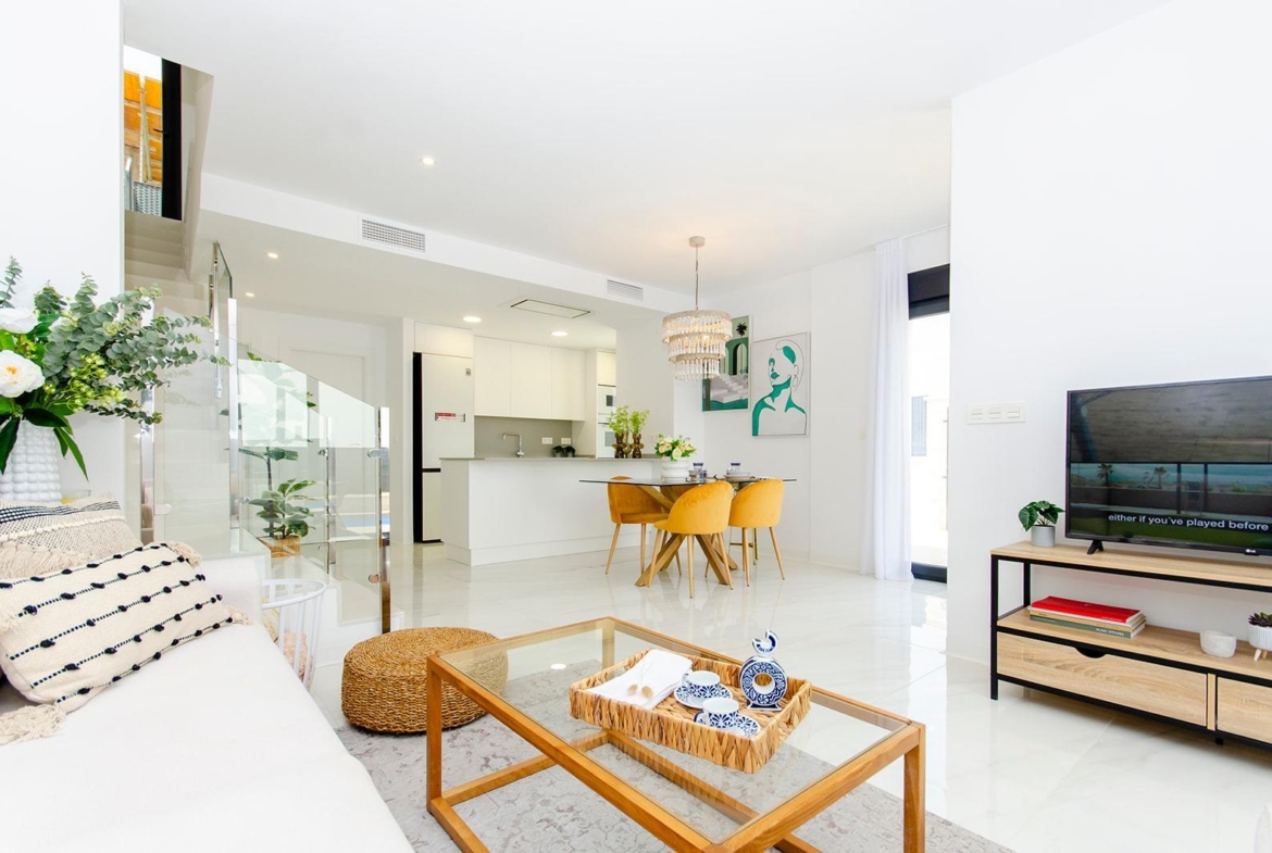 Bright open-plan living and dining area with modern kitchen in a new build semi-detached villa at Vistabella Golf Resort