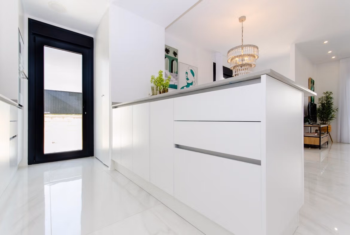 Luxury-New-Build-Semi-Detached-Villas-at-Vistabella-Golf-Resort-17 Bright modern kitchen in a new build semi-detached villa at Vistabella Golf Resort with white cabinets and marble floors