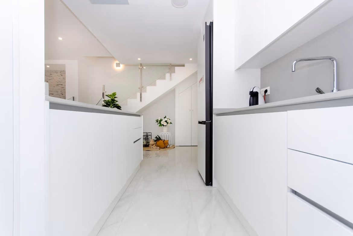 Luxury-New-Build-Semi-Detached-Villas-at-Vistabella-Golf-Resort-18 Bright modern kitchen with white cabinets and marble floor in a new build semi-detached villa at Vistabella Golf Resort