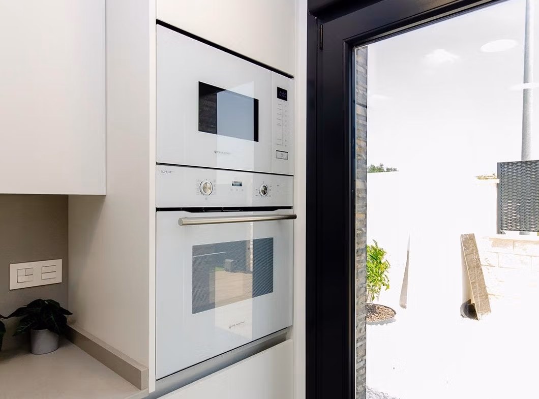 Luxury-New-Build-Semi-Detached-Villas-at-Vistabella-Golf-Resort-19 Compact modern kitchen with built-in oven and microwave in stylish new build semi-detached villa at Vistabella Golf Resort