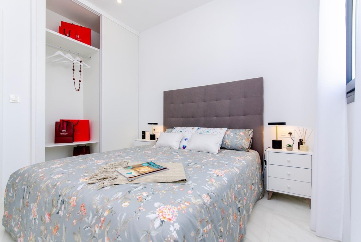 Bedroom with double bed, built-in wardrobe, and modern decor in a new build semi-detached villa at Vistabella Golf Resort