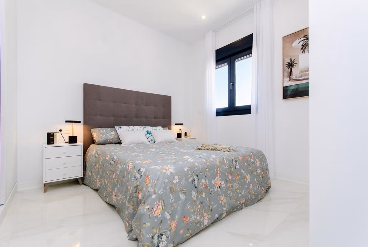 Luxury-New-Build-Semi-Detached-Villas-at-Vistabella-Golf-Resort-22 Bright bedroom with double bed and bedside tables in a new build semi-detached villa at Vistabella Golf Resort.