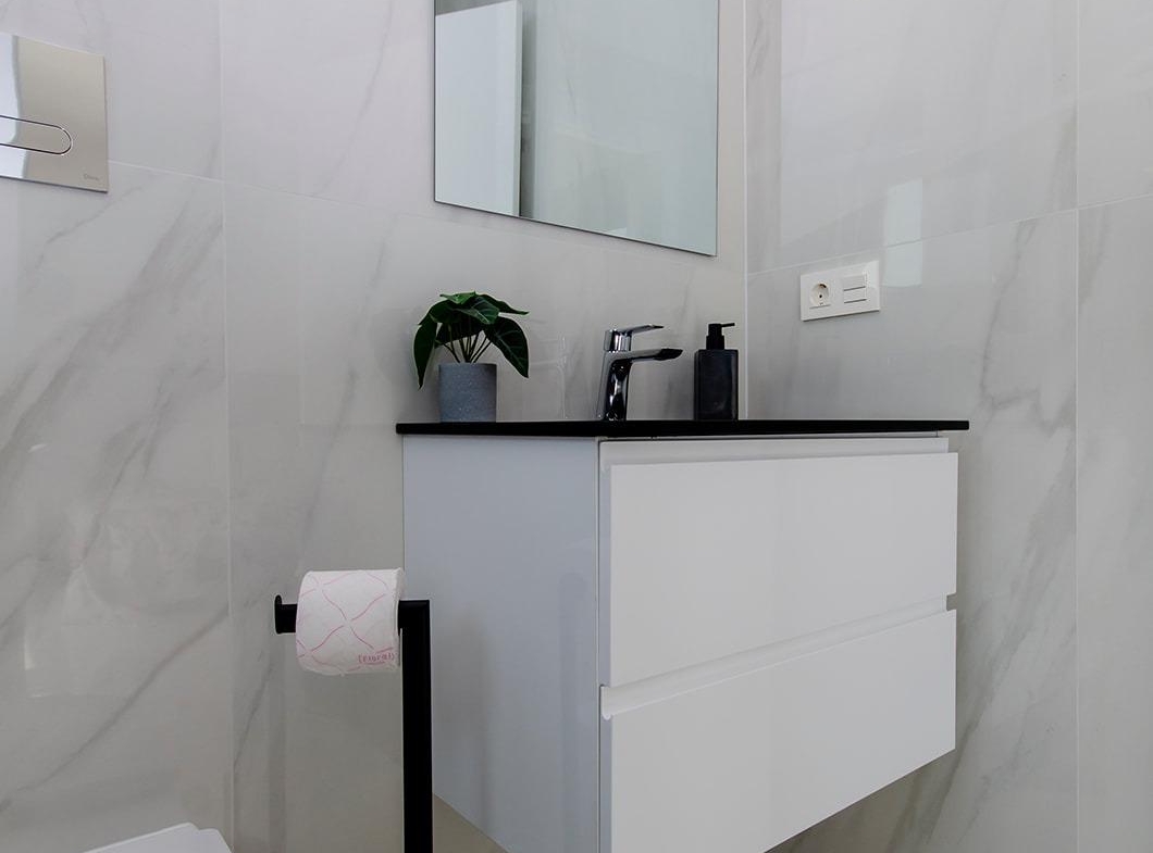 Modern bathroom with white floating vanity and mirror in stylish new build semi-detached villa at Vistabella Golf Resort