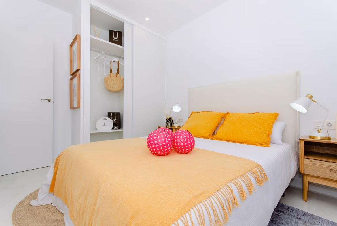 Luxury-New-Build-Semi-Detached-Villas-at-Vistabella-Golf-Resort-37 Bright bedroom with double bed and open wardrobe in new build semi-detached villa at Vistabella Golf Resort.