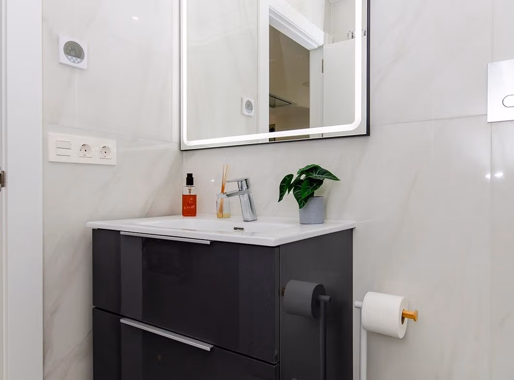 Luxury-New-Build-Semi-Detached-Villas-at-Vistabella-Golf-Resort-39 Compact modern bathroom with floating vanity and illuminated mirror in a semi-detached villa at Vistabella Golf Resort