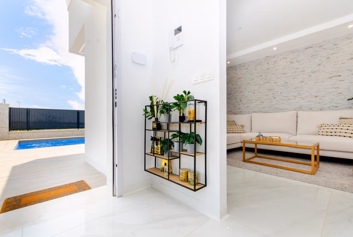 Luxury-New-Build-Semi-Detached-Villas-at-Vistabella-Golf-Resort-43 Interior view of a stylish new build semi-detached villa showing the living room and private pool in Vistabella Golf Resort.
