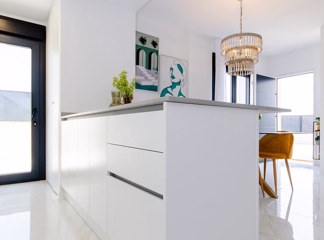 Luxury-New-Build-Semi-Detached-Villas-at-Vistabella-Golf-Resort-47 Bright modern kitchen with white island and dining area in new semi-detached villa at Vistabella Golf Resort