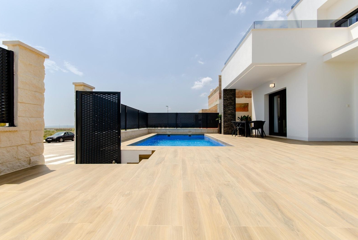 Spacious terrace with private pool and seating area in a new build semi-detached villa at Vistabella Golf Resort.
