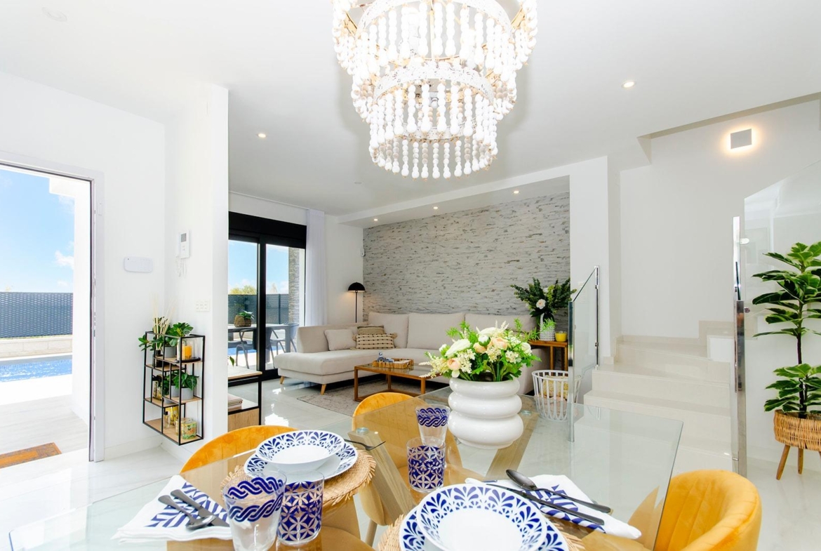 Bright open-plan living and dining area with modern decor in a new build semi-detached villa at Vistabella Golf Resort