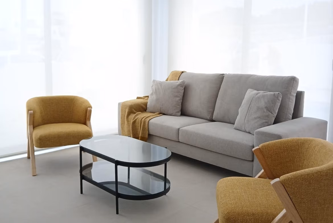 Bright living room with modern sofa and armchairs in new build quad villa for sale in Bigastro, Alicante