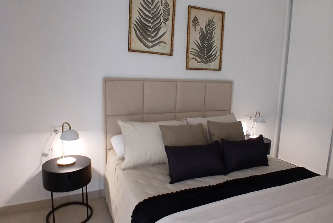 Bedroom with modern decor and neutral tones in a new build quad villa with basement for sale in Bigastro, Alicante
