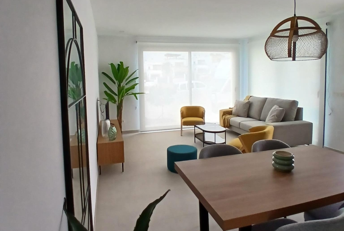 Bright living and dining area with modern furniture in a new build quad villa for sale in Bigastro, Alicante