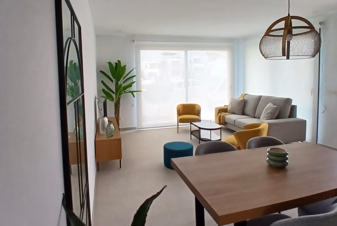 Bright living and dining area with modern furniture in a new build quad villa for sale in Bigastro, Alicante