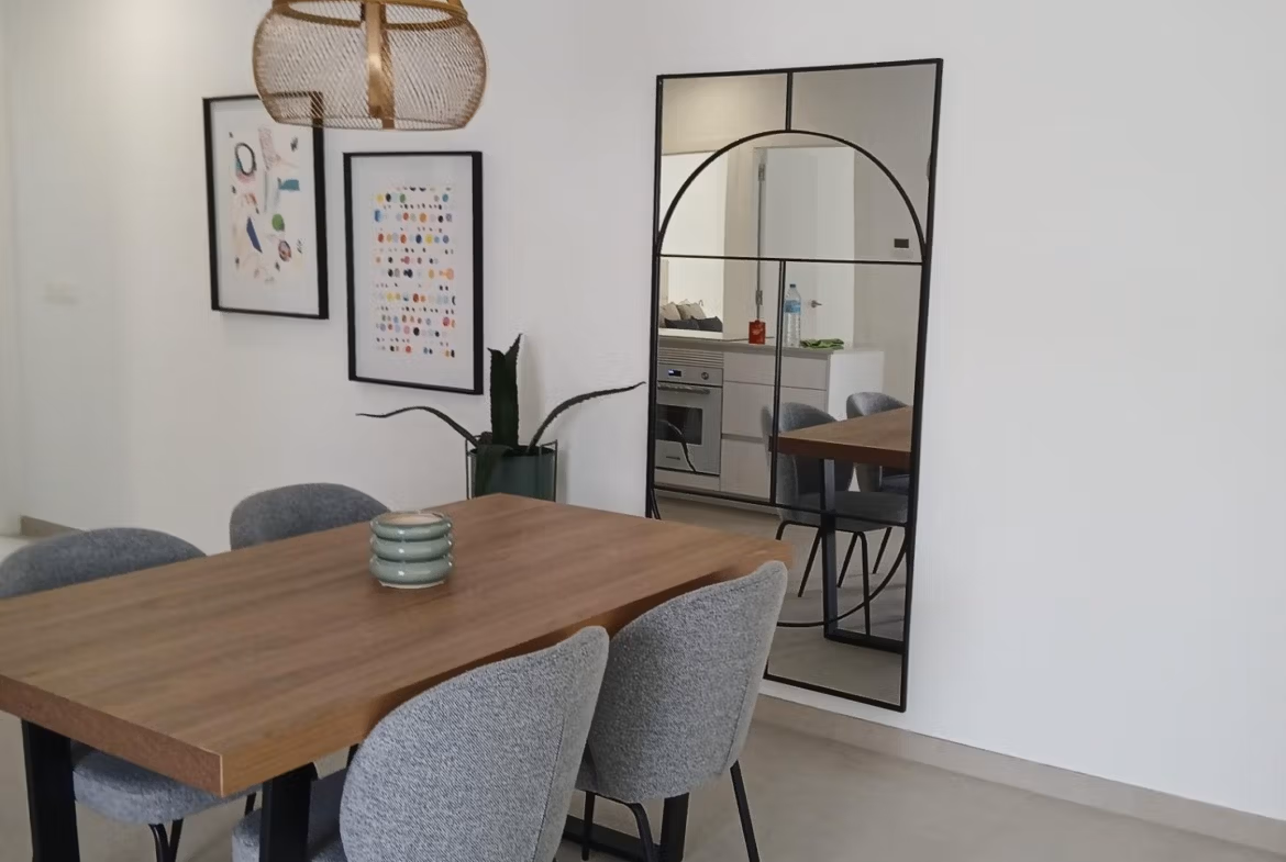 Dining area with wooden table and chairs in a new build quad villa in Bigastro, Alicante