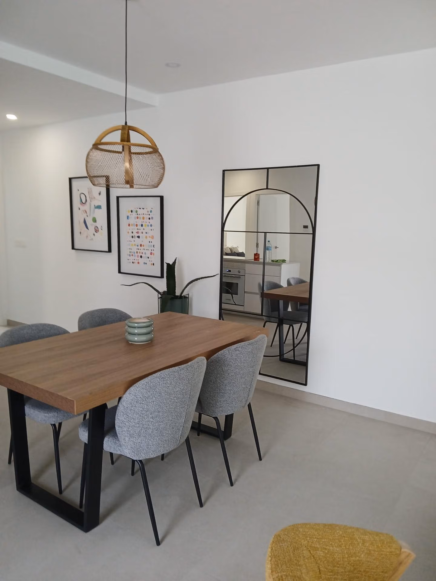 Dining area with wooden table and chairs in a new build quad villa in Bigastro, Alicante