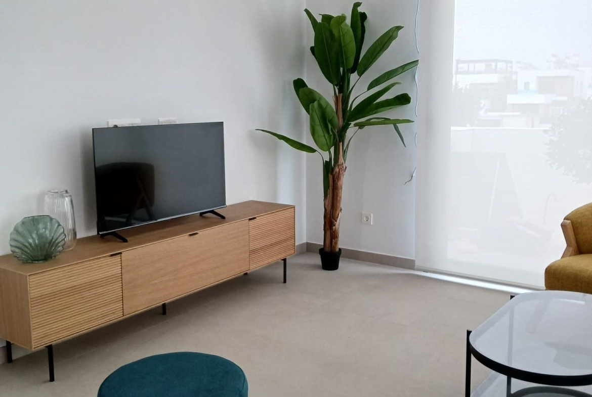 Living room with modern furniture and large window in a new build quad villa in Bigastro, Alicante.