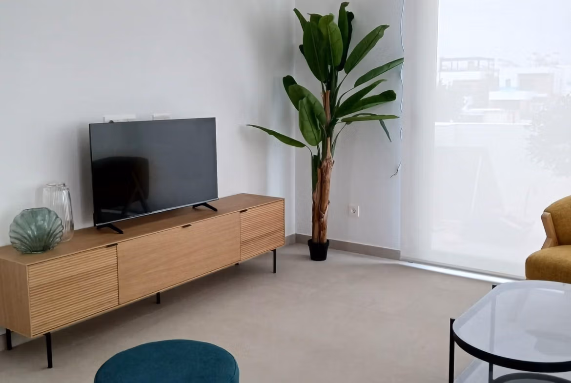 Living room with modern furniture and large window in a new build quad villa in Bigastro, Alicante.