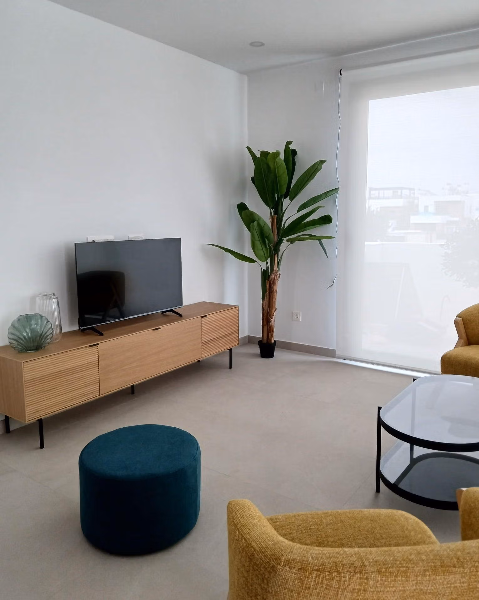 Living room with modern furniture and large window in a new build quad villa in Bigastro, Alicante.