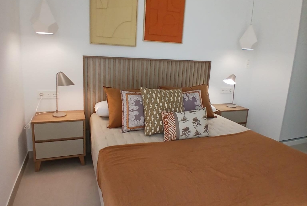 Bedroom with double bed, bedside tables, and pendant lights in a new build quad villa in Bigastro, Alicante