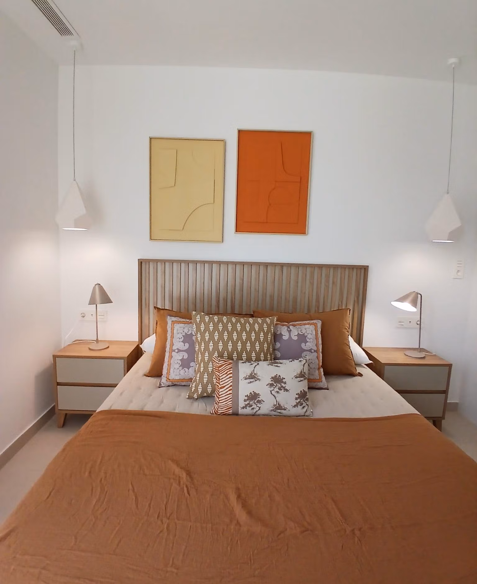 Bedroom with double bed and decorative pillows in a new build quad villa in Bigastro, Alicante