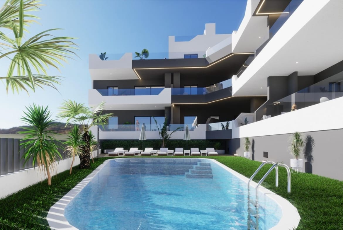 Outdoor pool and terrace area of a new build 3 bedroom penthouse in Benijofar with modern architecture and greenery.