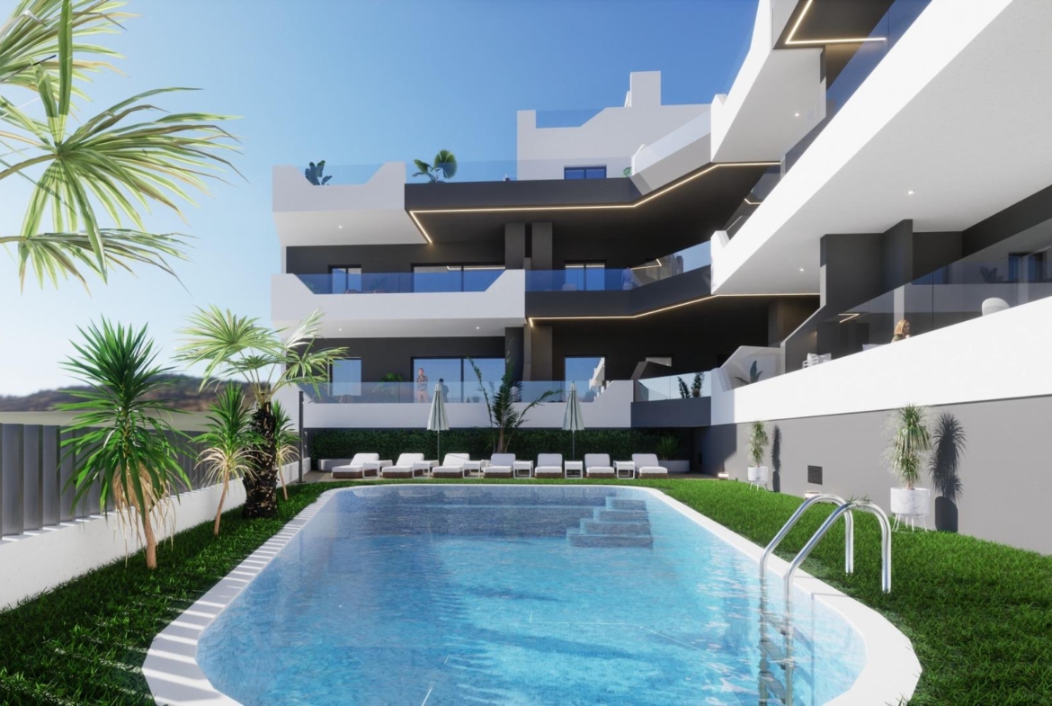 Modern new build ground floor apartment in Benijofar featuring a pool and sun loungers in a landscaped courtyard