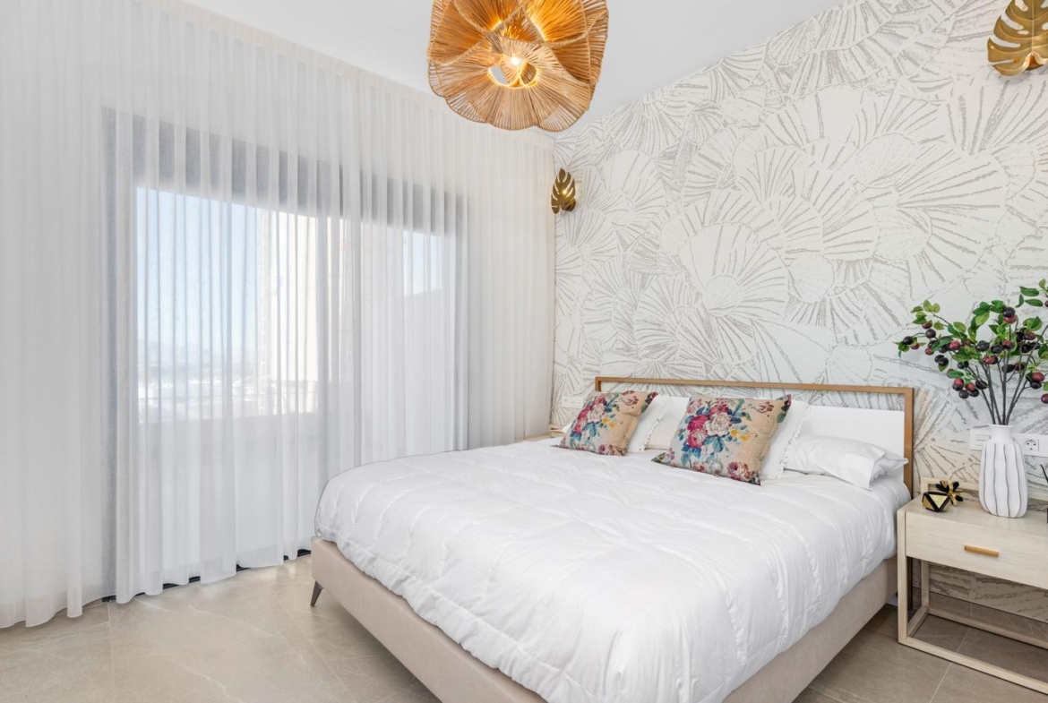 Bright bedroom with floral accents and sheer curtains in a new 2-bedroom ground floor apartment in Benijofar