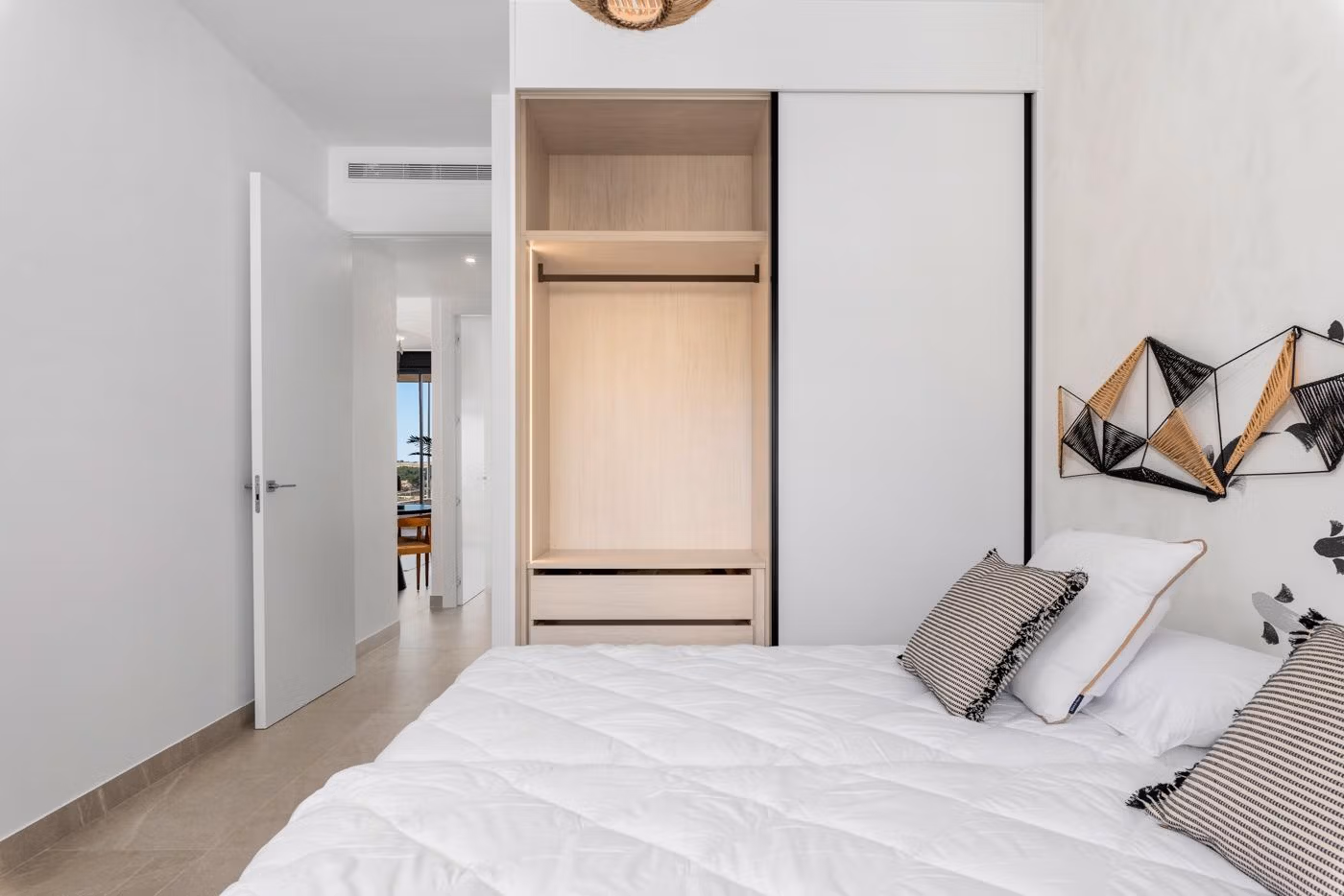 Bedroom with white bed and built-in wardrobe in modern new build 3 bedroom apartment in Benijofar, Costa Blanca South