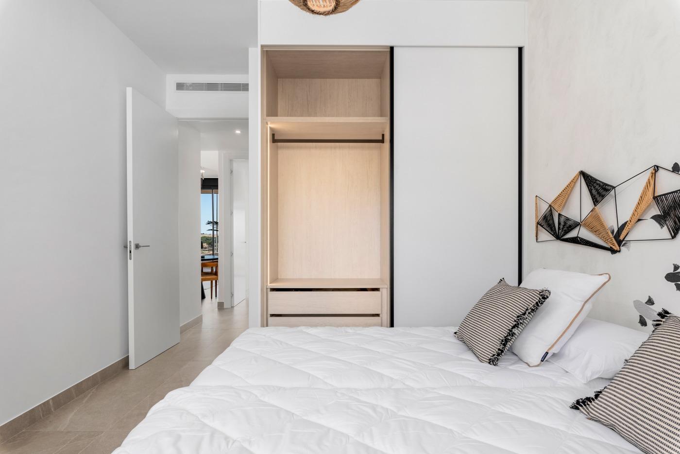 NEW-BUILD-BUILD-RESIDENTIAL-COMPLEX-IN-BENIJOFAR-16 Bright bedroom with built-in wardrobe in a new 4-bedroom ground floor apartment for sale in Benijofar.